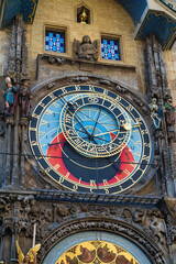 A detailed view of Prague’s astronomical clock set in a Gothic façade, featuring blue, red, and gold dials, sculptures, and intricate mosaics that blend science. Prague , Czech republic