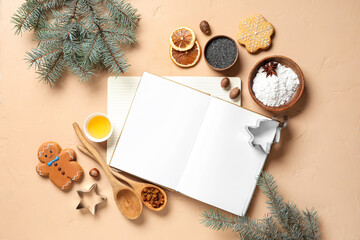 Blank recipe book with gingerbread cookie, ingredients and Christmas branches on beige background