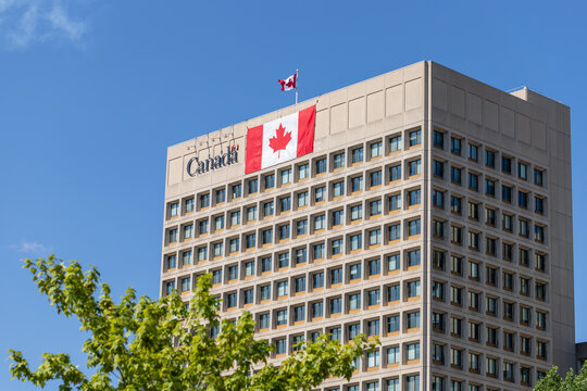 Ottawa, Ontario - July 1, 2024: Government building with Canadian flag on Canada Day. Department of National Defence headquarters.