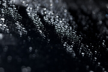 water drops on glass in close-up. abstract dark background with beautiful bokeh. Mockup for your logo. horizontal wallpaper or web banner.