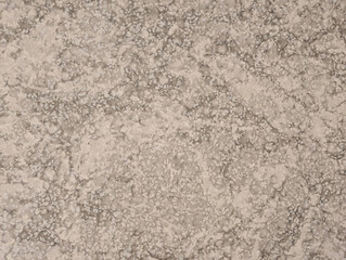 Top view of semi-gloss quartz tile texture with soft relief, irregular patterns and neutral gray tones. Textured tiled interior floor surface background. Archiecture, interior design, home decor.
