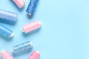 Thread spools on blue background