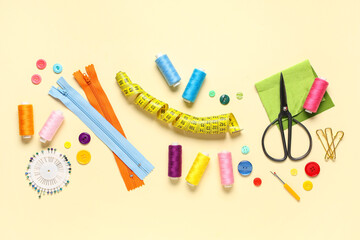 Different sewing supplies on beige background