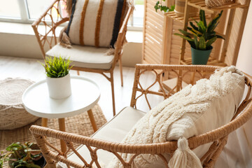 Wicker armchair with pillow in living room