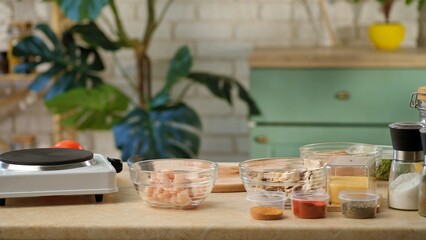 Cozy kitchen countertop featuring various ingredients in bowls, ready for meal preparation.