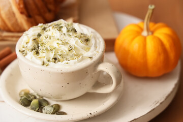 Cup of pumpkin latte on tray, closeup