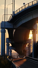 Modern bridge against the backdrop of sunset, architecture and light of the evening city.