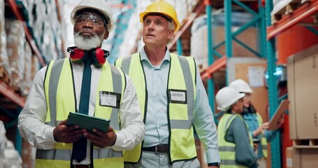 Walking, warehouse and men on tablet talking for inspection, quality control and inventory. Shipping, factory team and mature supervisors on digital tech for logistics, supply chain and distribution - Powered by Adobe