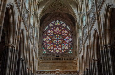 Fototapeta premium Beautiful aerial and detailed view of St. Vitus Cathedral in Prague Castle, Czech Republic, showcasing Gothic architecture, gargoyles, stained glass, and the historic city skyline.