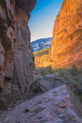 Cody, Wyoming, at Buffalo Bill State Park,  has cliffs & mountains for rock climbing. Sun hits cathedral shape cliffs and you can see mountain ridges beyond, a beautiful view.