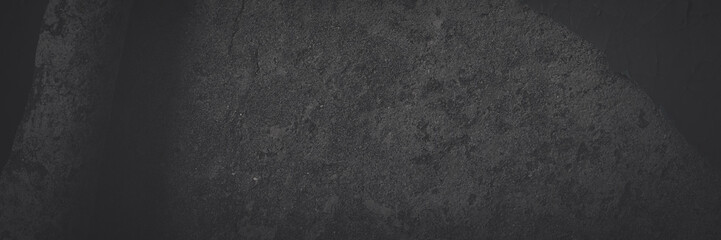 Dark wide panoramic background. Peeling paint on a concrete wall. Faded dark texture of old cracked...