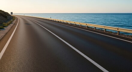 A coastal road curves, hugging the shoreline with a calm ocean view