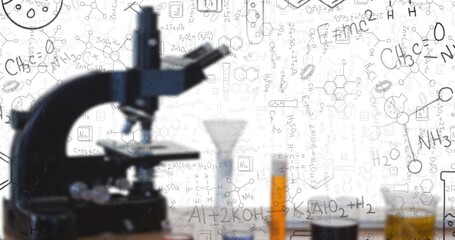 Featuring black microscope standing on lab bench with vials, tubes and formula doodles, copy space