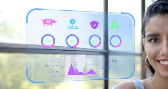 Interacting Indian woman using finance interface at window, with piggy bank line graph, copy space