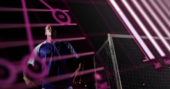 Gazing player in blue-white jersey on night field with metal goal frame net and pink-neon overlay - Powered by Adobe