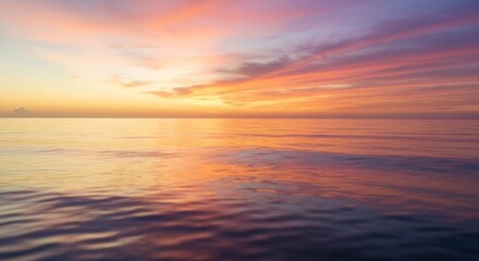 Obraz premium Colorful sunset paints the sky and sea with vibrant orange, pink and purple hues