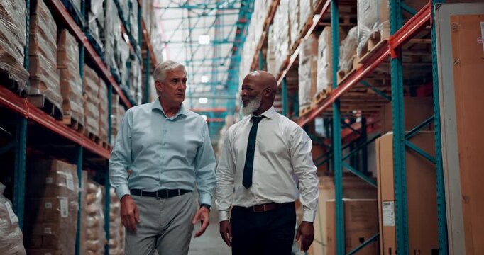 Logistics, walking and business men in warehouse with inspection, inventory or freight order. Discussion, planning and supply chain managers with cargo distribution in collaboration at storehouse.