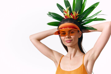 Vibrant summer portrait of a model with tropical headwear and orange attire, showcasing a cheerful...