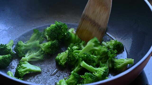 Stir fried broccoli in cooking pan, Asian food 
