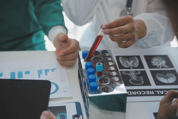 Medical technology network team meeting concept. Doctor hand working smart phone modern digital tablet laptop computer graphics chart interface, sun beams effect photo