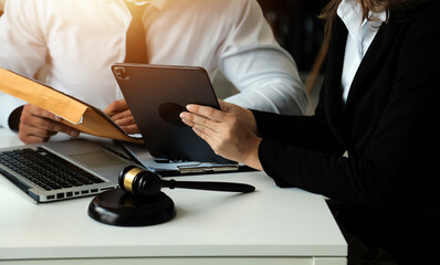 Judge gavel with Justice lawyers having team meeting at law firm in background. Concepts of law.