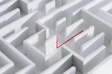 White maze with single red line marking path to exit, symbolizing problem solving, strategy, and determination in minimalistic style