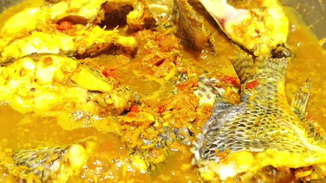 Fresh fish curry in a pan with herbal curry paste