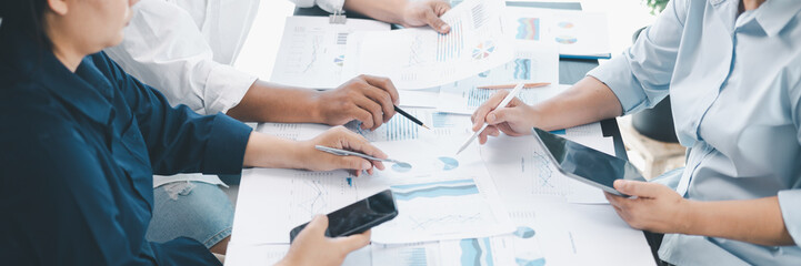 Panorama of corporate teamwork with people discussing financial reports, pointing at charts, planning business strategy, analyzing data and collaborating in office meeting for professional success.