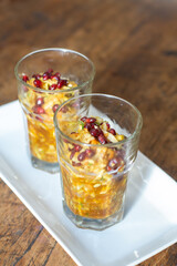 Traditional Indonesian fruit salad rujak serut in glass with spicy palm sugar dressing and pomegranate