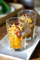 Traditional Indonesian fruit salad rujak serut in glass with spicy palm sugar dressing and pomegranate