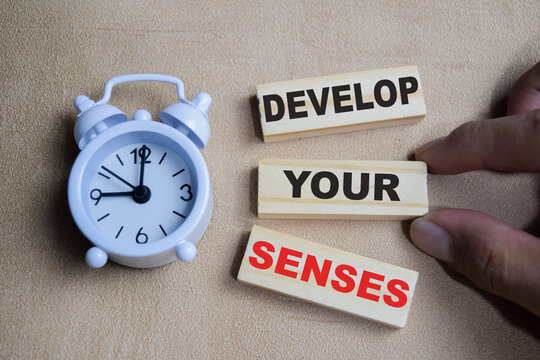 Develop your senses on stacked wooden cubes on the table. Business and finance concept