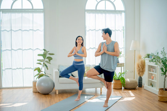 Asian family stay at home together on holiday. Love couple lifestyle. Yoga and exercise concept.