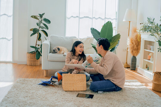 Asian love couple moving to new house. Family lifestyle at home.