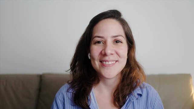 Hispanic woman looking at camera talking on video call. Technology concept