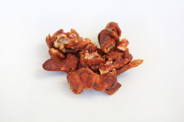 Peeled tamarind against white background, preparation process of tamarind for cooking.