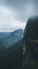 Misty mountain landscape with dramatic cliffs and valley view