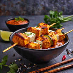 Paneer tikka is an indian cuisine dish with grilled paneer cheese with vegetables and spices. Indian food