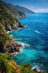 Naklejka premium Rugged coastline meets azure waters, green hills backdrop