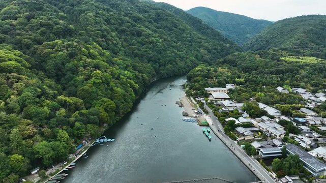 Ōi River (Katsura River) With Lush Forest Mountain In Arashiyama District In Kyoto, Japan. Aerial Drone Shot