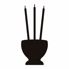 Black silhouette of candles in a bowl, symbolic of mourning and remembrance
