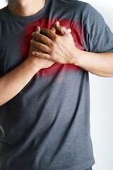 Man holds chest in pain, a symptom of heart attack or anxiety, health concept, medical emergency, danger