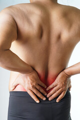 Man experiencing intense lower back pain seeking relief and treatment, aching muscles and inflammation causing discomfort and limited mobility