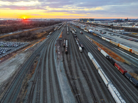 Aerial View of a Large Train Yard at Sunset
