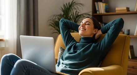 Fototapeta premium Woman relaxing in armchair with laptop comfortable