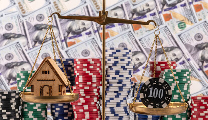 A conceptual story about ludomania (gambling addiction) with a symbolic house, golden scales and casino betting chips against a background of $100 bills.