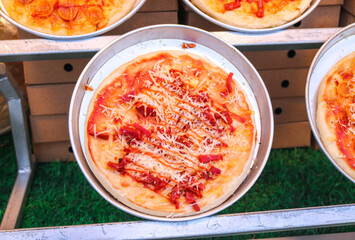Close-up on round pizza with abundant delicious garnish of served on plate