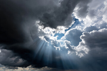 Sunlight breaking through heavy storm clouds