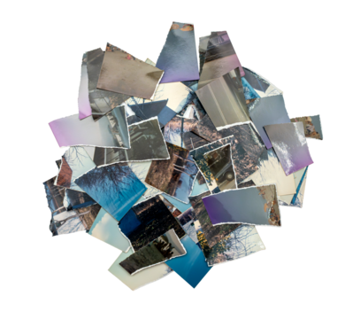 A pile of torn vintage photographs scattered in a random composition, symbolizing memory, nostalgia