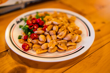 Salted peanuts peel mix with chilli on a dish is an appetizer for beer or a drink at Thai restaurant