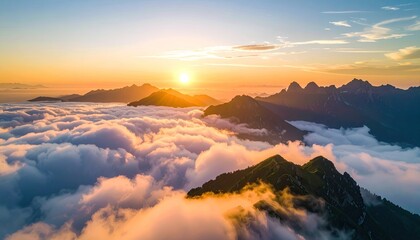 Obraz premium Majestic Mountain Peaks Emerging From A Sea Of Clouds At Golden Hour Sunrise With Sun Flare And Orange Sky